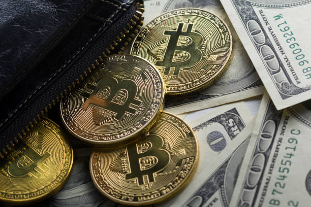 Golden Bitcoins on US dollars. Electronic money exchange concept.